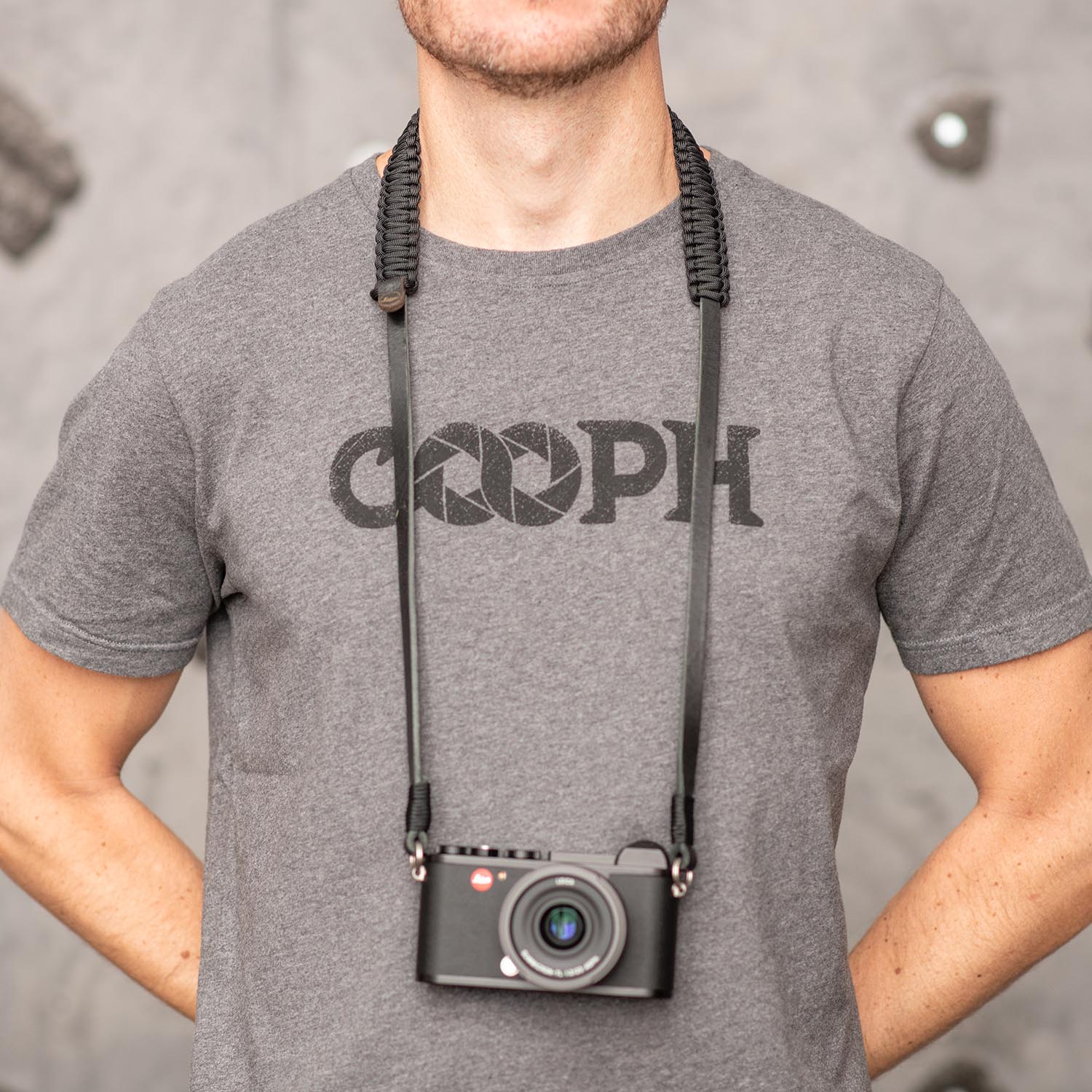 Photographer wearing black Leica Paracord Strap