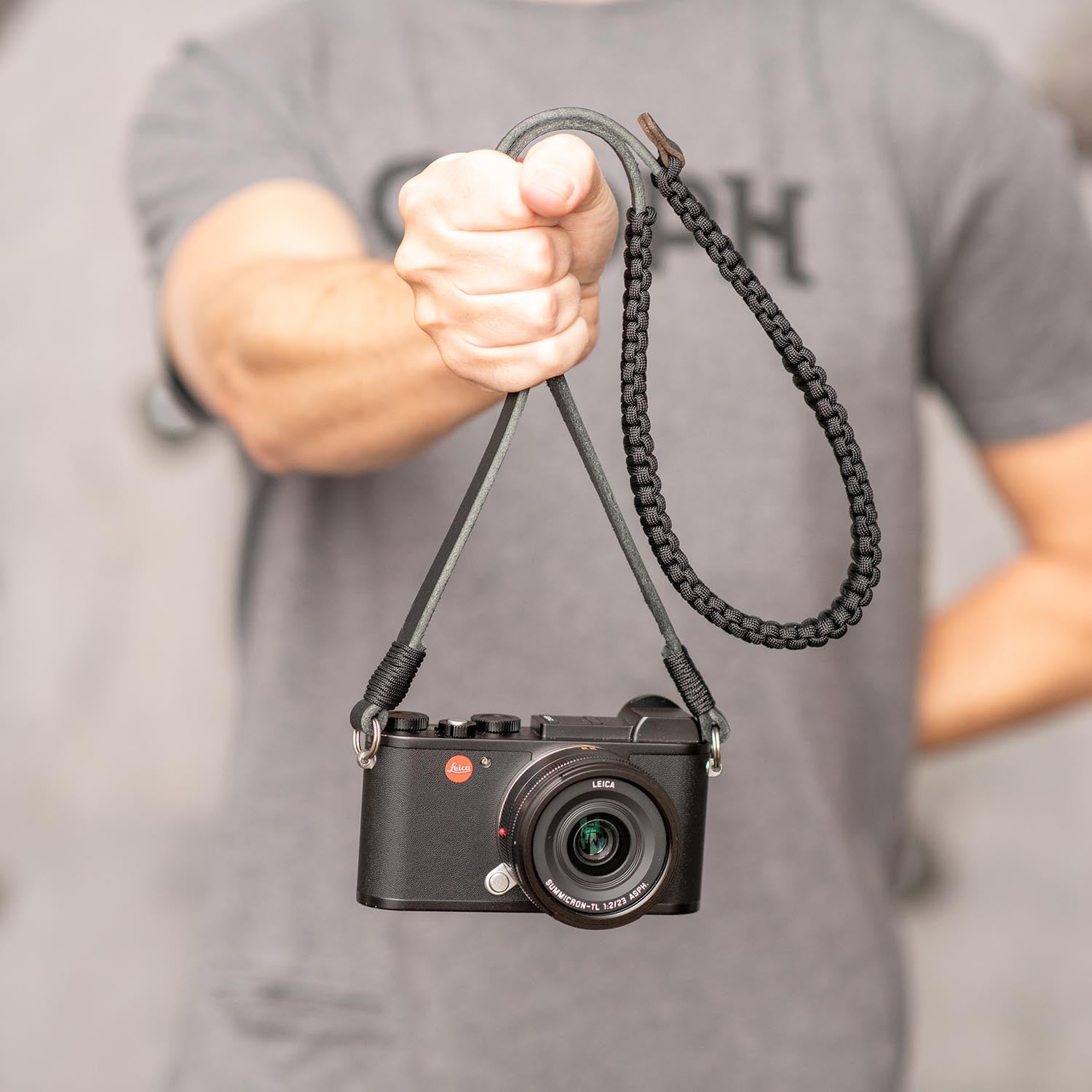 Holding camera by paracord strap