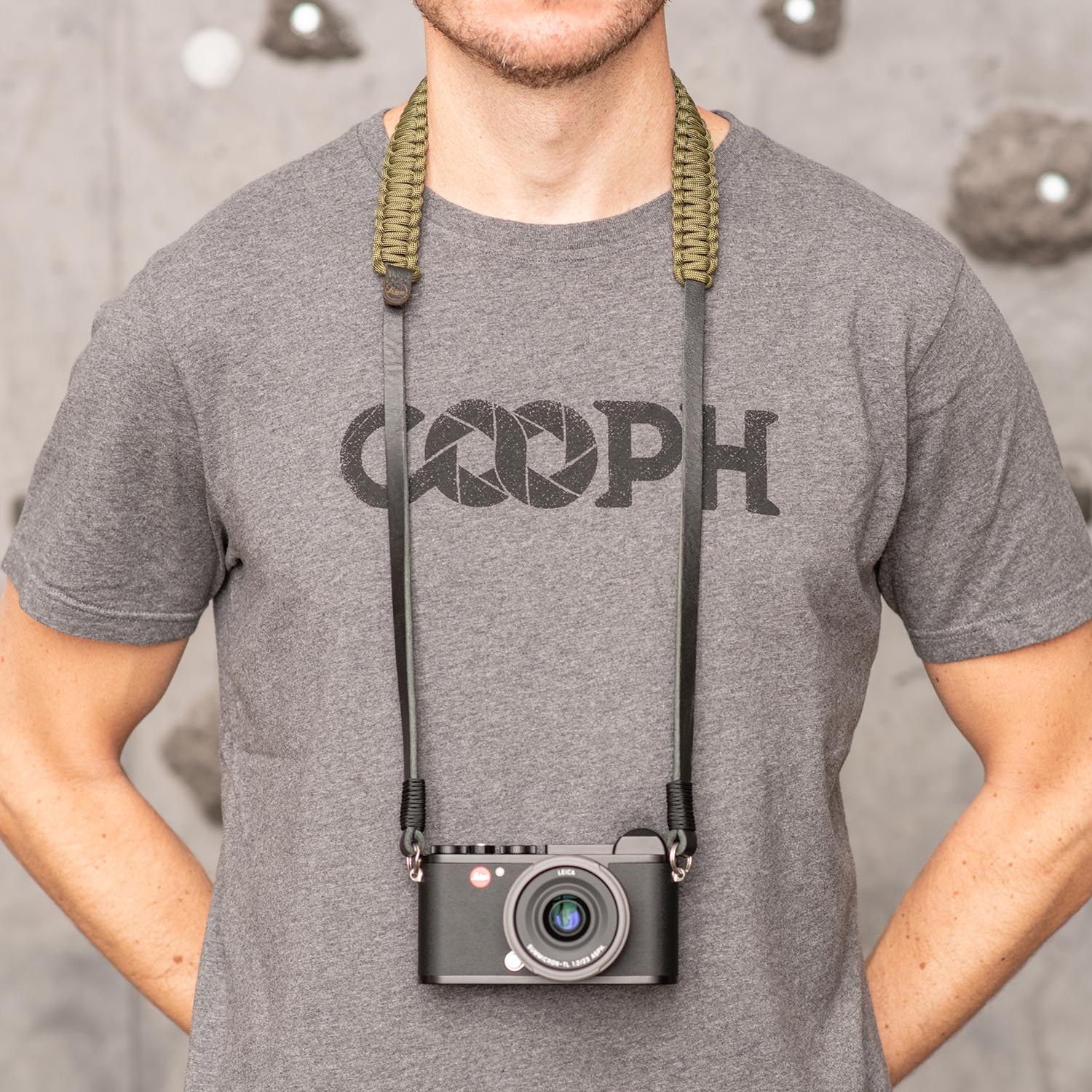 Photographer wearing olive Leica Paracord Strap