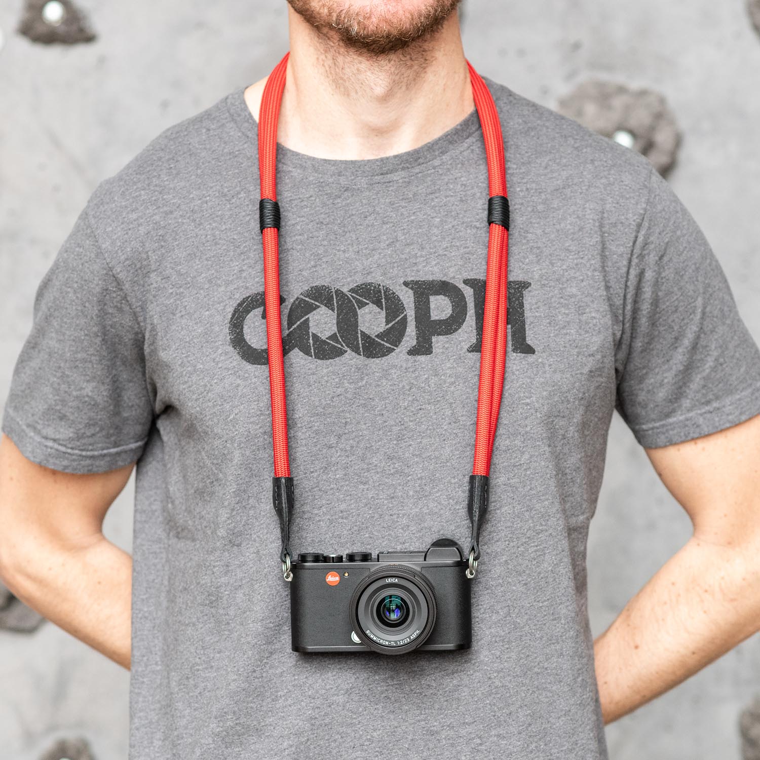 Photographer wearing red Leica Double Rope Strap